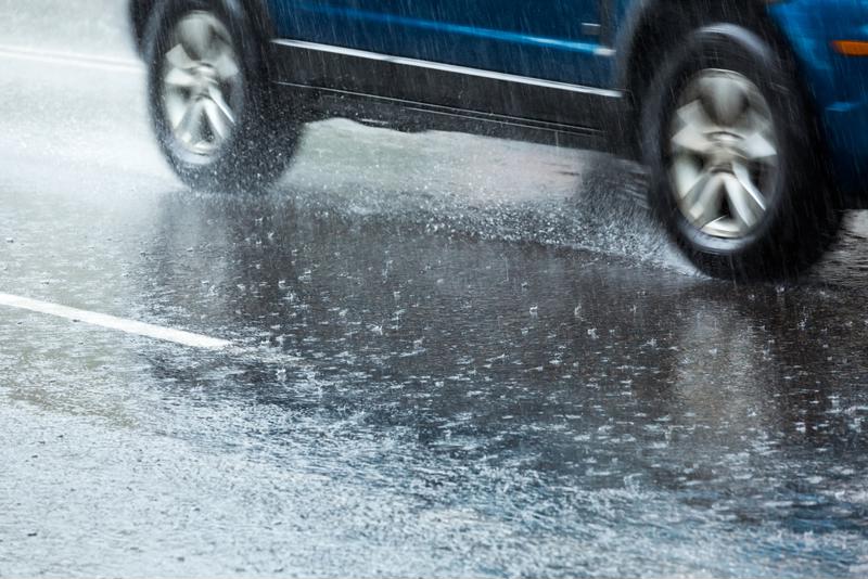 A hailstorm affects driving conditions on a highway.