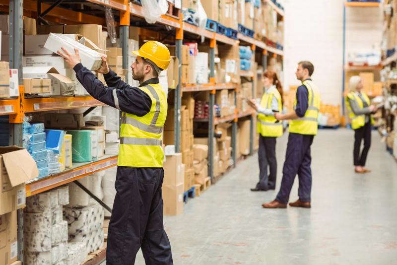 Employees in a warehouse pick orders.